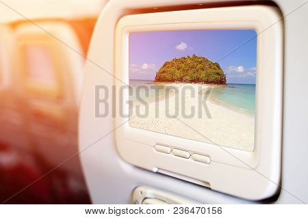 Aircraft In Flight Entertainment Seat-back Tv Screens Showing A Picture Of Beautiful Beach & Crystal