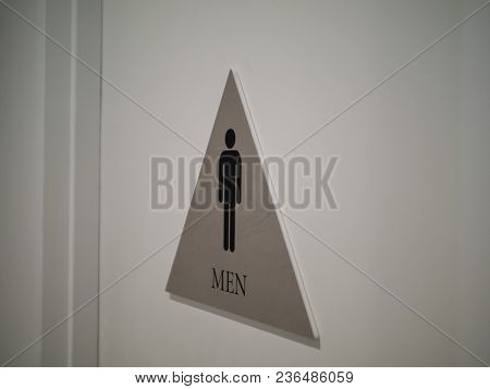 Men’s Restroom Sign Affixed To Door In Office Building Indoors