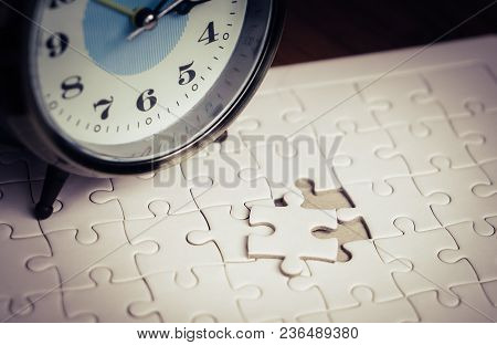 Time Counting Down On Alarm Clock To Palce The Last Jigsaw