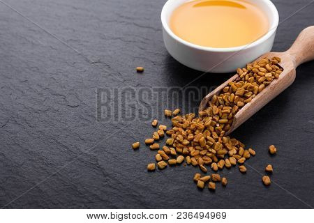 Fragrant Grains Of Fenugreek On A Rustic Background.