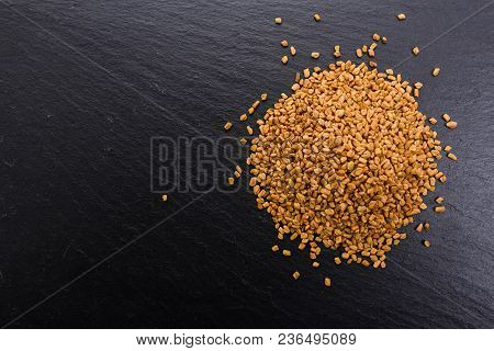 Fragrant Grains Of Fenugreek On A Rustic Background.