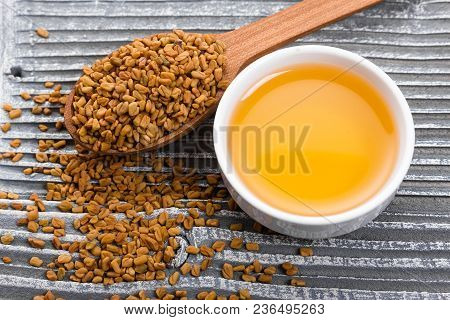 Fragrant Grains Of Fenugreek On A Rustic Background.