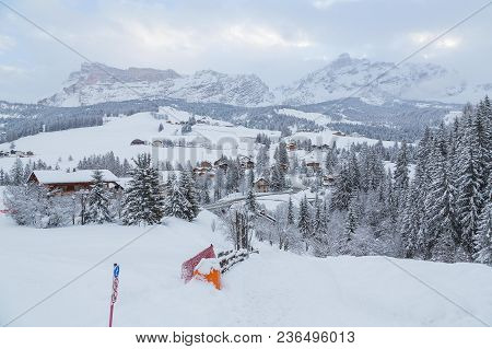 Amazing Panoramic View On The Winter Valley Village In The Dolomite Mountains Near Alta Badia. Aston