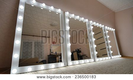 Four Make-up Mirrors Stand In The Room And Are Lit