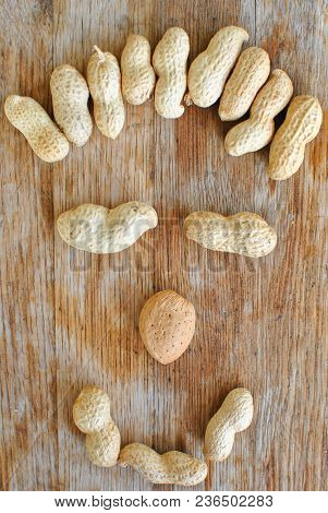 Smiling Face From Nuts On Light Wood