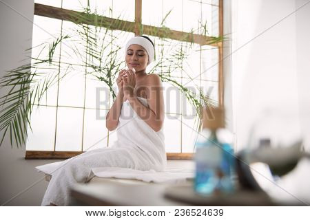 Delicious Smell. Delighted Nice Woman Closing Her Eyes While Enjoying The Smell Of Aroma Oil