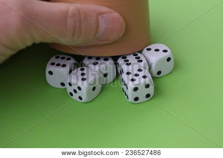 Dice Game With Dice Cup On Green Table Casino Concept
