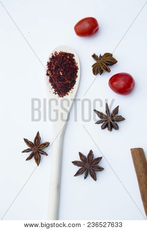 Cooking Hot Spicy Food Concept. Dry Spices In Wooden Spoon And Cloves, White Background, Top View