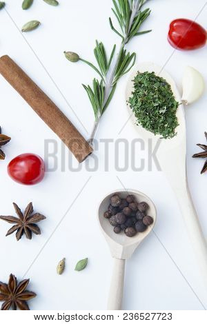 Cooking Hot Spicy Food Concept. Dry Spices And Herbs In Wooden Spoons, Fresh Herbs And Cinnamon, Whi
