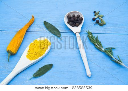 Cooking Hot Spicy Food Concept. Dry Spices And Herbs In Wooden Spoons And Dry Yellow Chili Pepper On