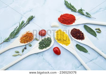 Cooking Hot Spicy Food Concept. Dry Spices And Herbs In Wooden Spoons White Marble Background, Top V