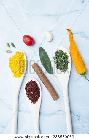 Cooking Hot Spicy Food Concept. Dry Spices And Herbs In Wooden Spoons, Cinnamon And Chili Pepper, Wh