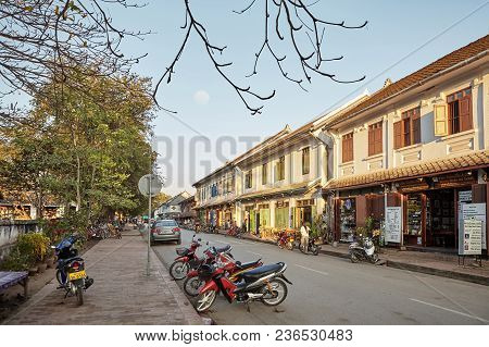 Luang Phrabang / Laos - Jan 28, 2010: The Old Building Of Luang Phrabang With Bikes And Car Parking 