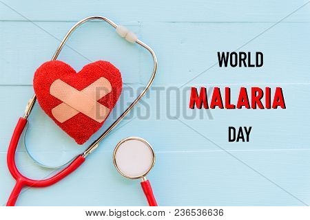World Malaria Day April 25, Healthcare And Medical Concept. Stethoscope, Handmade Red Heart, Thermom