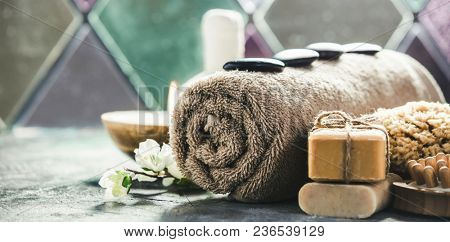 Spa concept with sea salt, massage herbal balls, candles and essencial oils on old stone background. Natural cosmetics and wellness conceptSpa. Spa treatment.