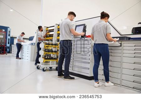 Engineers Selecting Tools For Use On Machinery In Factory