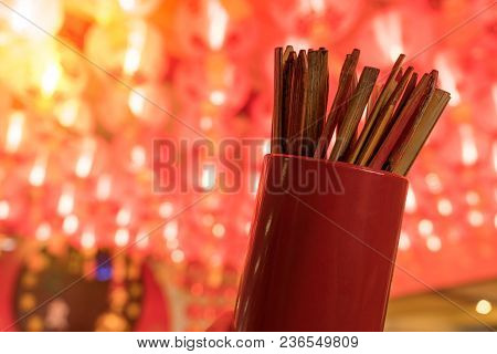 Close Up Of Fortune Sticks Or Seam-si Or Chi-chi Sticks, Shake For Future Fore With Red Chinese Pape