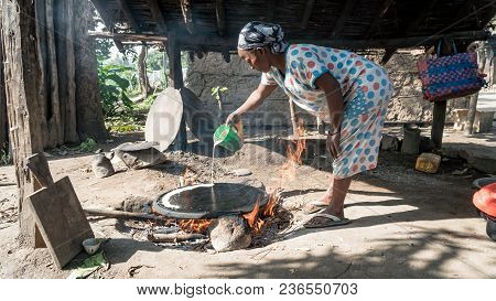 Omo, Ethiopia - September 2017: Ethiopean Woman Cooking Ethiopean Bread Called Injera