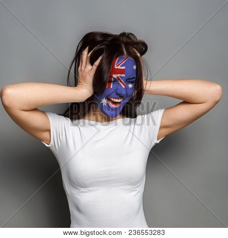 Portrait Of Happy Woman With The Flag Of Australia Painted On His Face. Football Or Soccer Team Fan,