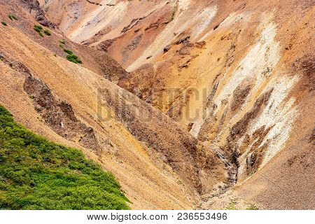 Steep Ravine With Red Hills In Lonsoraefi In Iceland, Europe