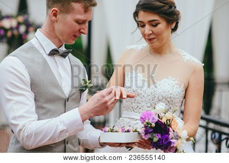 Bride And Groom Exchange Rings At The Wedding