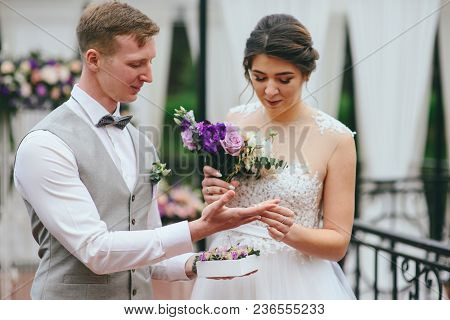 Bride And Groom Exchange Rings At The Wedding