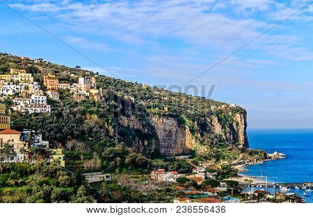 Picturesque Steep Rocky Coast With Colorful Houses And The Small Harbor Of Vico Equense, Near Naples