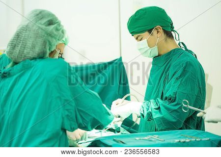 The Surgery Team Working Together At The Operating Room In The Hospital.
