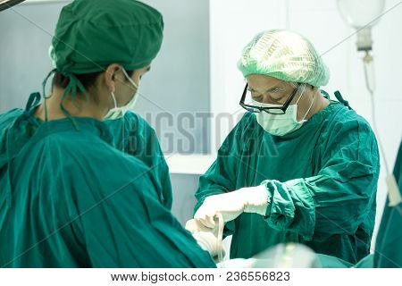The Surgery Team Working Together At The Operating Room In The Hospital.