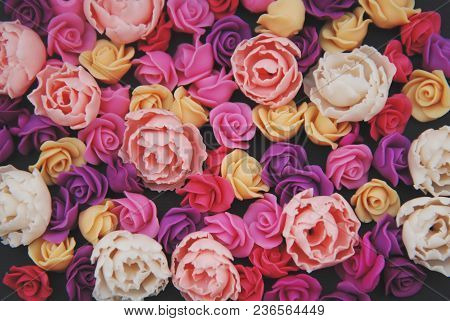 Mix Of Pink And Peach Fake Plastic Mini Rosess Flowers Black Background Copy Space. Craft, Art,