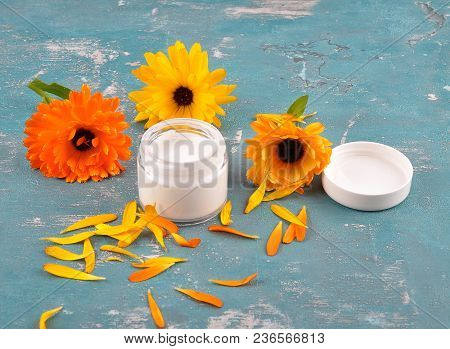 Colorful And Crisp Image Of Natural Cosmetics And Common Marigold On Weathered Concrete