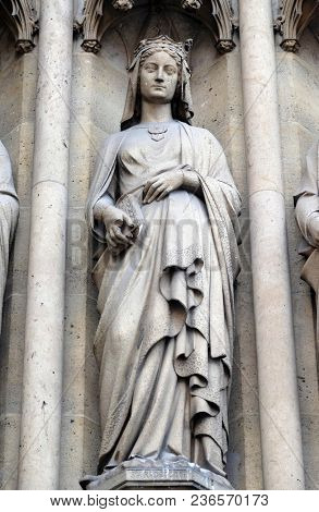 PARIS, FRANCE - JANUARY 05: Saint Radegund, statue on the portal of the Basilica of Saint Clotilde in Paris, France on January 05, 2018.
