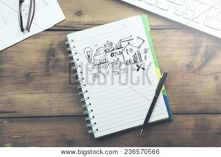 Sketching Good Ideas With Keyboard  On Wooden Table