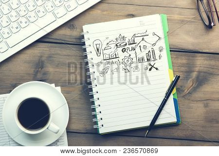 Sketching Good Ideas With Keyboard  On Wooden Table