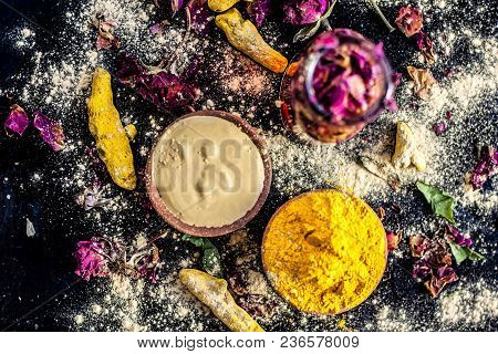 Ayurvedic Ubtan Of Turmeric/haldi And Mulpani Mitti Or Fuller’s Earth With Rose Water On A Black Sur