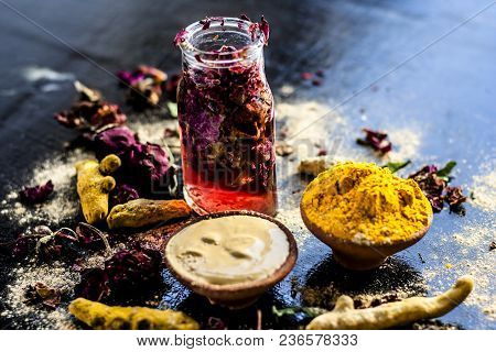 Ayurvedic Ubtan Of Turmeric/haldi And Mulpani Mitti Or Fuller’s Earth With Rose Water On A Black Sur
