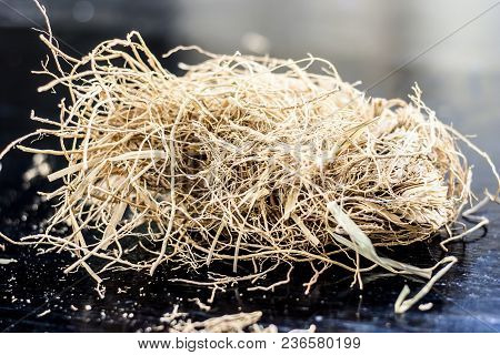 Ayurvedic Herb Vetiver Grass Or Khus On A Black Wooden Surface Used As A Flavoring Agent In Most Of