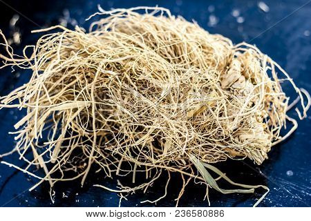 Ayurvedic Herb Vetiver Grass Or Khus On A Black Wooden Surface Used As A Flavoring Agent In Most Of