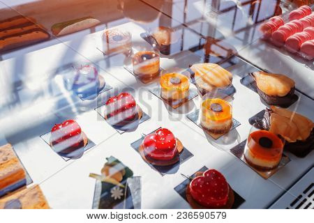 Assortment Of Different Cakes On Cafe Showcase. Variety Of Flavours. Chocolate And Cream Cakes In St