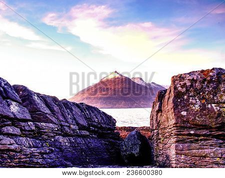 The Stony Beach And Cliff Of Rocky Bay. Blue Tones Of February Sunset, Pink Horizon.  Dark Slipery B