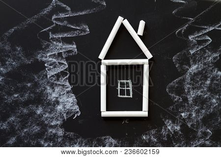 House Chalk Hand Drawn On The Middle Of A Blackboard.
