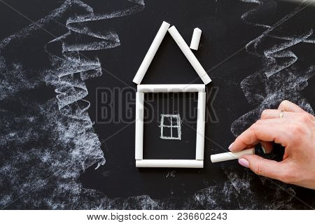 House Chalk Hand Drawn On The Middle Of A Blackboard.