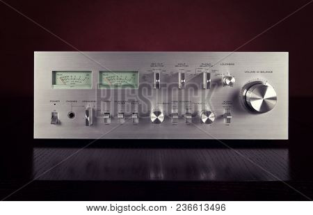 Vintage Stereo Amplifier Frontal Panel with VU meters Dark Background Closeup 