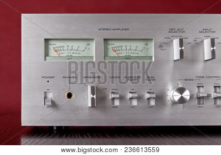 Vintage Stereo Amplifier Frontal Panel with VU meters Dark Background Closeup 