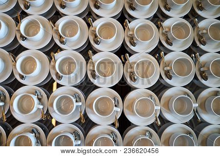 Set Of Empty White Ceramic Tea Or Coffee Cup And Saucers, Top View. Group Of Empty Cups Stacked In R
