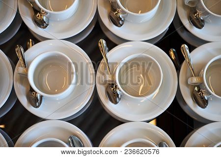 Set Of Empty White Ceramic Tea Or Coffee Cup And Saucers, Top View. Group Of Empty Cups Stacked In R