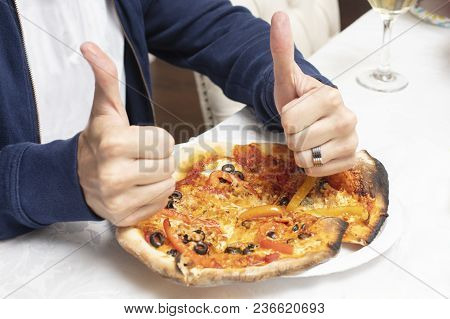 Man Giving A Baked Homemade Pizza A Thumbs Up