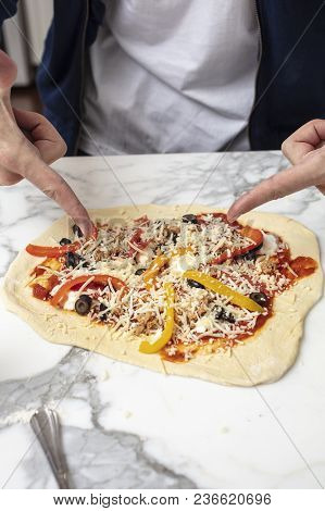 Man Pointing At Homemade Pizza Before Baking In The Oven