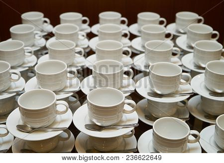 Set Of Empty White Ceramic Tea Or Coffee Cup And Saucers, Top View. Group Of Empty Cups Stacked In R