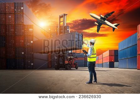 Truck With Cargo Container On Road In Shipping Yard Or Dock Yard Against Sunrise